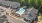 A bird's eye view of an apartment complex with a swimming pool and a parking lot.